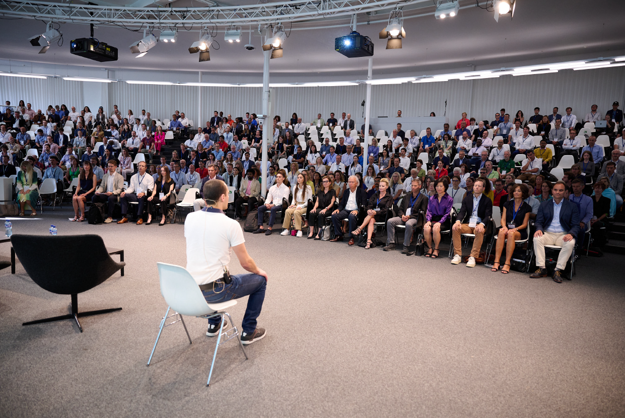 Neil Truncik presenting auditorium Picture of Neil Truncik presenting to an auditorium full of people during a conference
